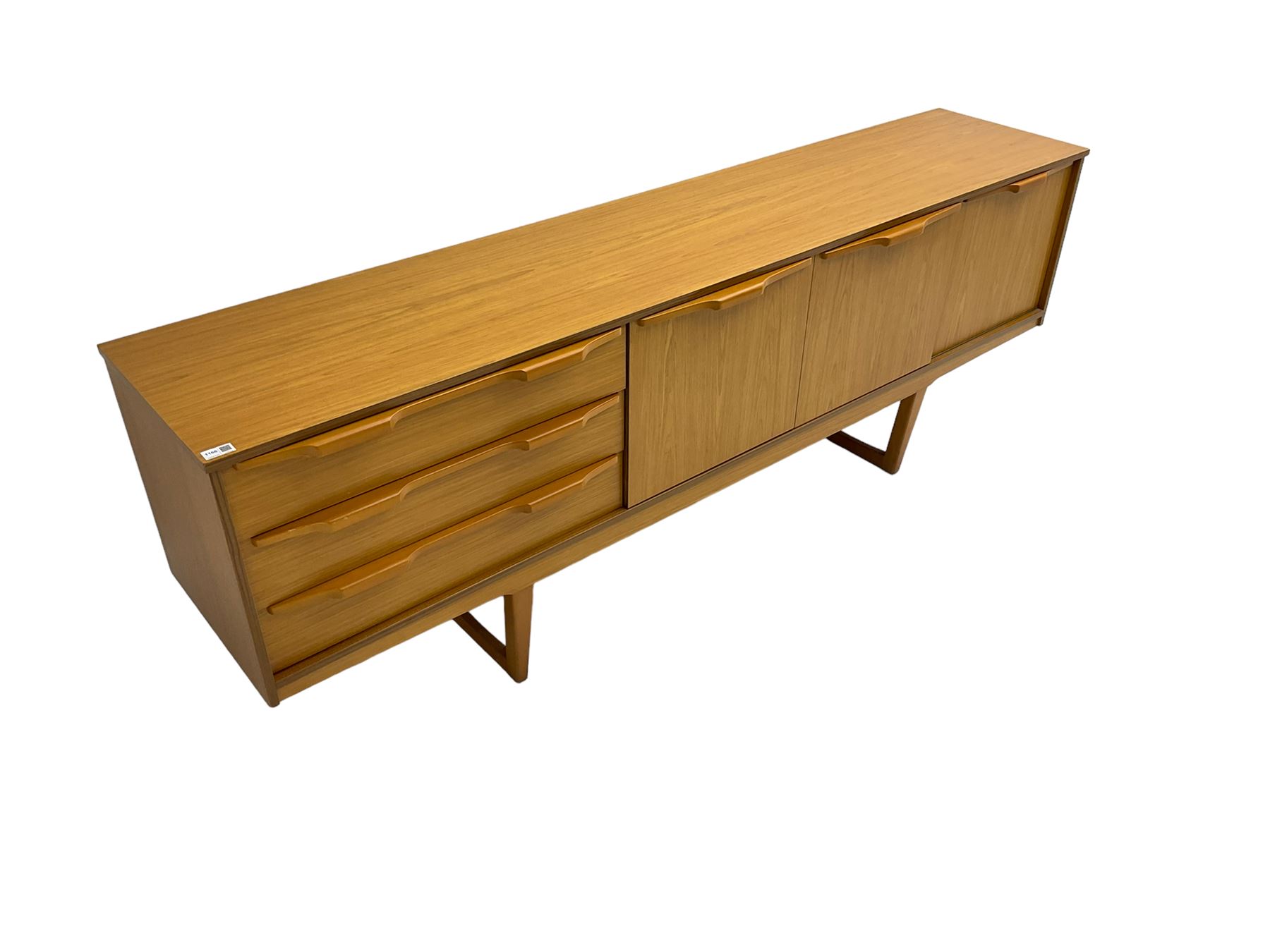 Stonehill Furniture (SF) Ltd - mid-20th century teak sideboard, rectangular topover three drawers, two cupboard doors and fall-front drinks cupboard, raised on square tapering supports