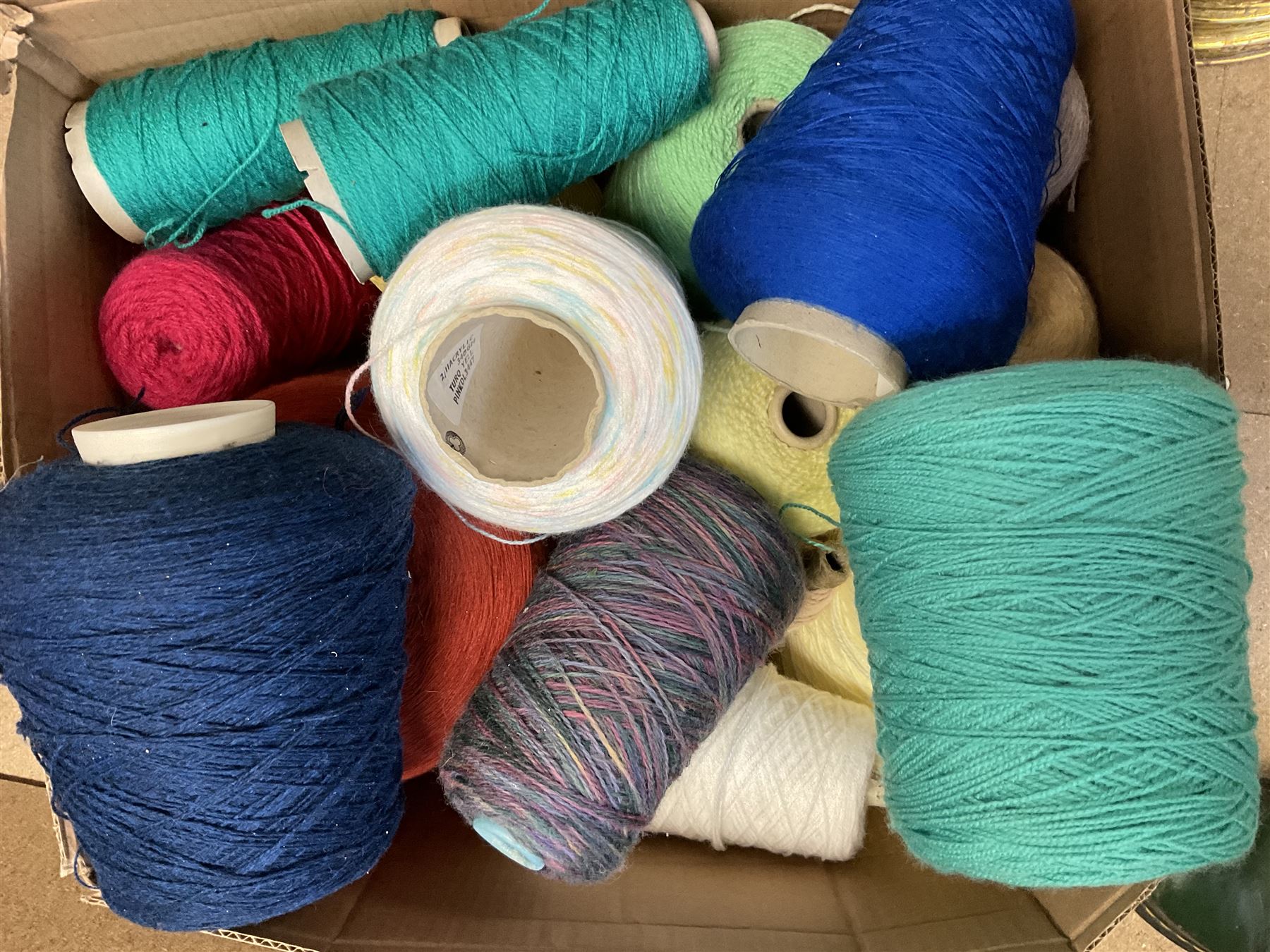  Brother cased knitting machine model KH-890 together with Brother Ribbing attachment model KH-850, knitting machine yarn cones in assorted colours, selection of knitting patterns etc