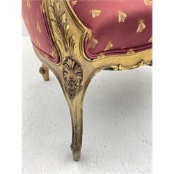 Victorian carved giltwood armchair, the shaped cresting rail decorated with shell cartouche and flower head motifs, down swept arms with acanthus leaf and scrolled terminals, upholstered in red ground fabric decorated with repeating gilt motif pattern, shell carved supports