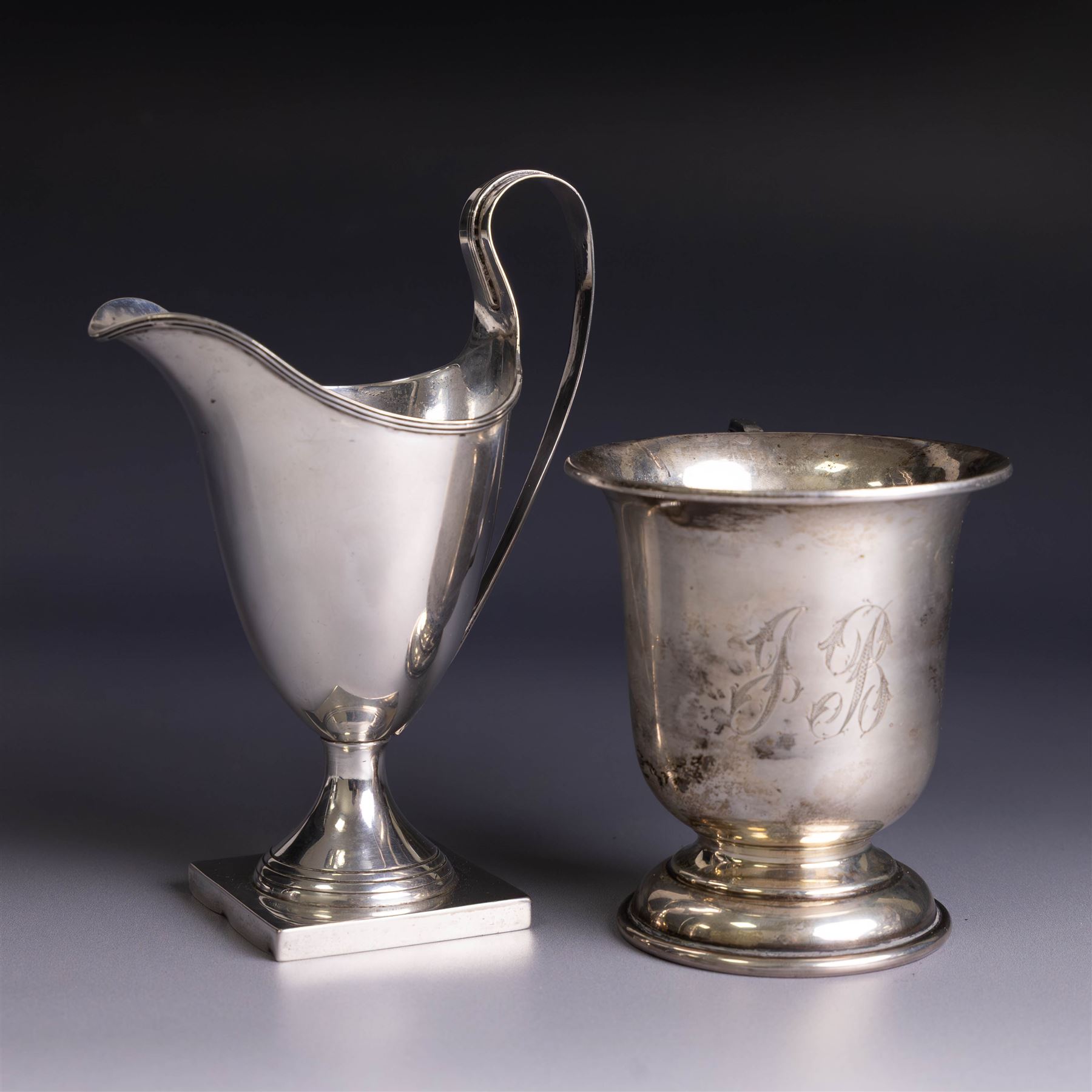 Edwardian silver helmet shaped cream jug, upon a square base, hallmarked John Rose, Birmingham 1905, together with a 1930s silver christening mug with engraved initials to body, hallmarked Aaron Lufkin Dennison, Birmingham 1936, jug including handle H13cm