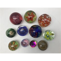 Collection of glass paperweights, to includes examples with internal air bubble inclusions and ones with internal flowers (11)