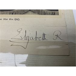 King George VI and Queen Elizabeth - the photograph and signatures only from a 1945 Christmas card depicting The Royal Family waving from the balcony of Buckingham Palace, on V-E Day Tuesday May 8th 1945, signed 'George R.I. Elizabeth R.'