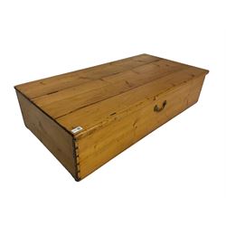 19th century pine shallow blanket chest, rectangular hinged top, single brass handle to front, on inset castors