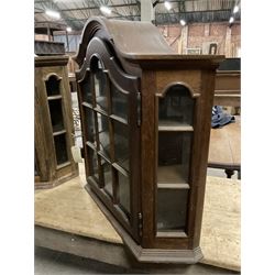 Dutch design oak wall hanging apothecary cabinet, of arched form with single astragal style glazed door enclosing single shelf (W69cm D18cm H69cm); together with another similar of corner form (W75cm D48cm H69cm) - THIS LOT IS TO BE COLLECTED BY APPOINTMENT FROM THE OLD BUFFER DEPOT, MELBOURNE PLACE, SOWERBY, THIRSK, YO7 1QY