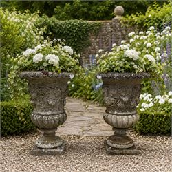 Pair of quality antique weathered three-piece composite stone garden urns, the flared rim ...