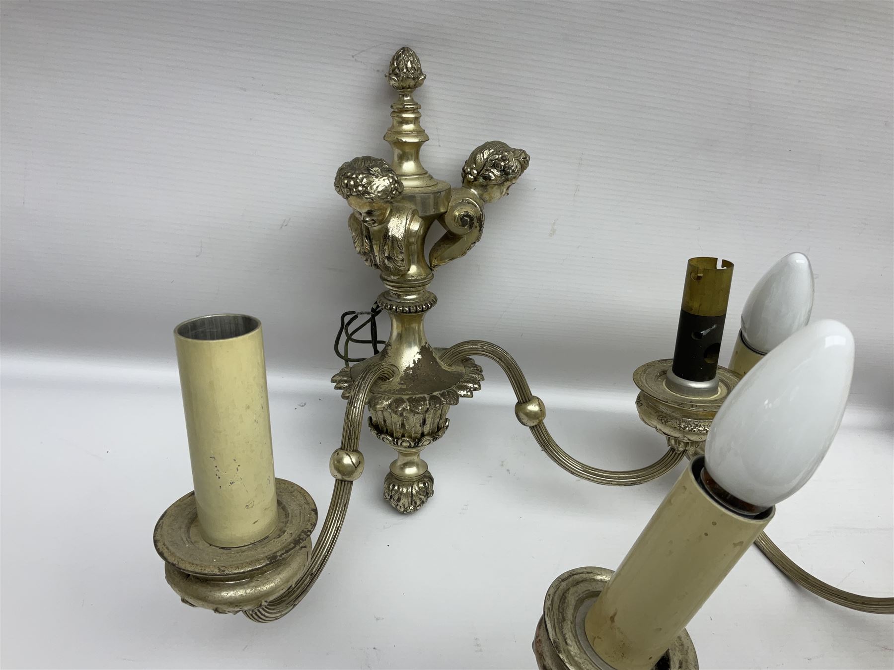 Siz branch silvered chandelier, decorated with acanthus leaves and putti, together with two matching three branch wall sconces, chandelier D65cm