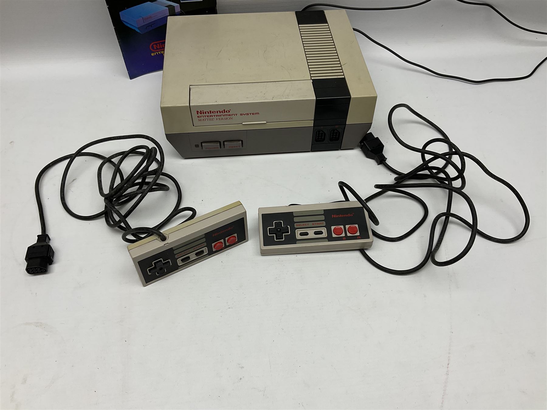 Nintendo Entertainment System (1985) console with two controllers, accessories and instruction booklet. NES Games ‘Duck Hunt’ with Nintendo Zapper gun, ‘Pinball’ and ‘Super Mario Bros.’, all with original sleeves and instruction booklets. NES game ‘Super Mario Bros. 2’ cartridge only