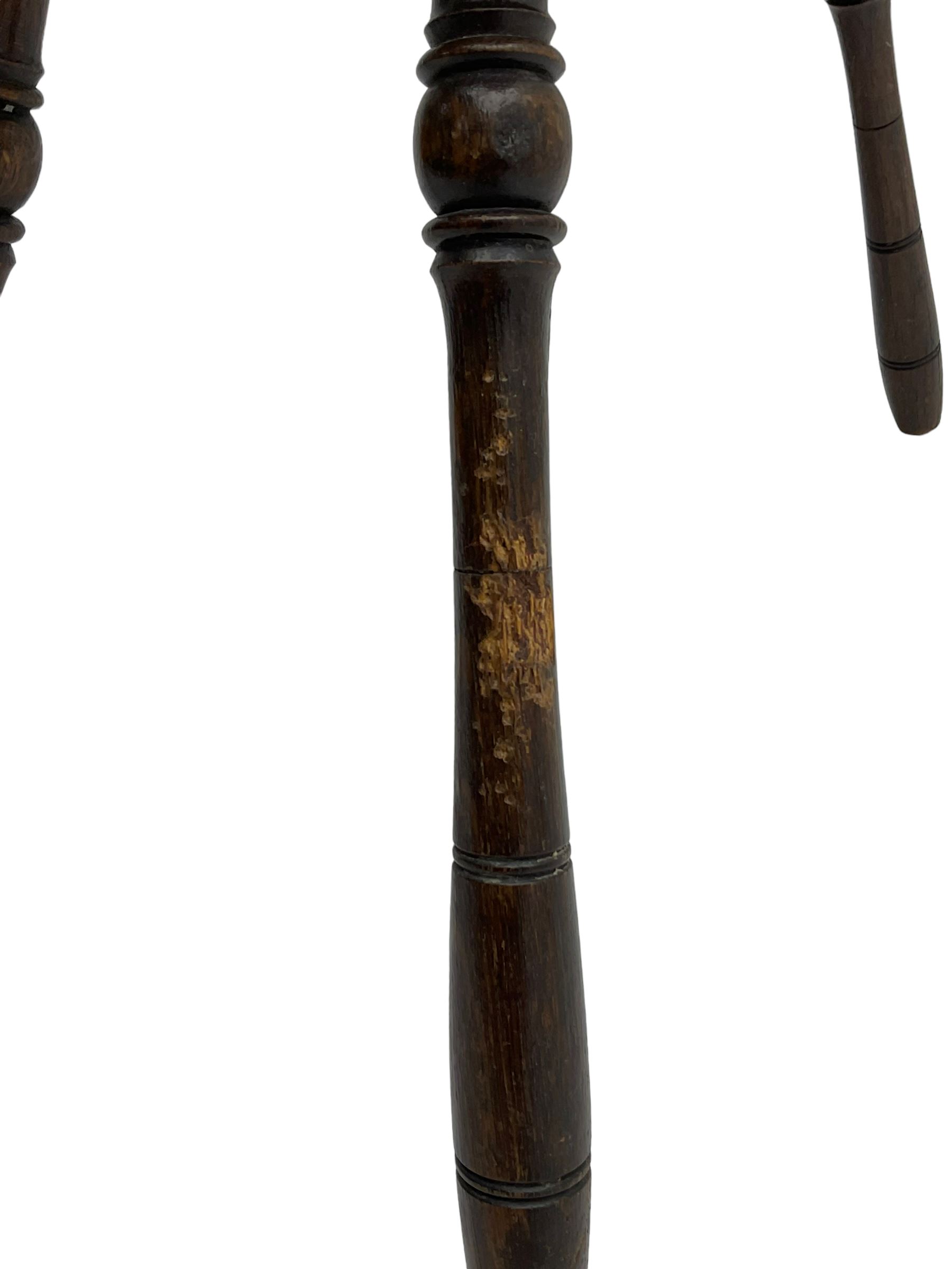 Late 19th century oak stool, rectangular dished top relief carved with floral lunettes and central insignia, on turned splayed supports