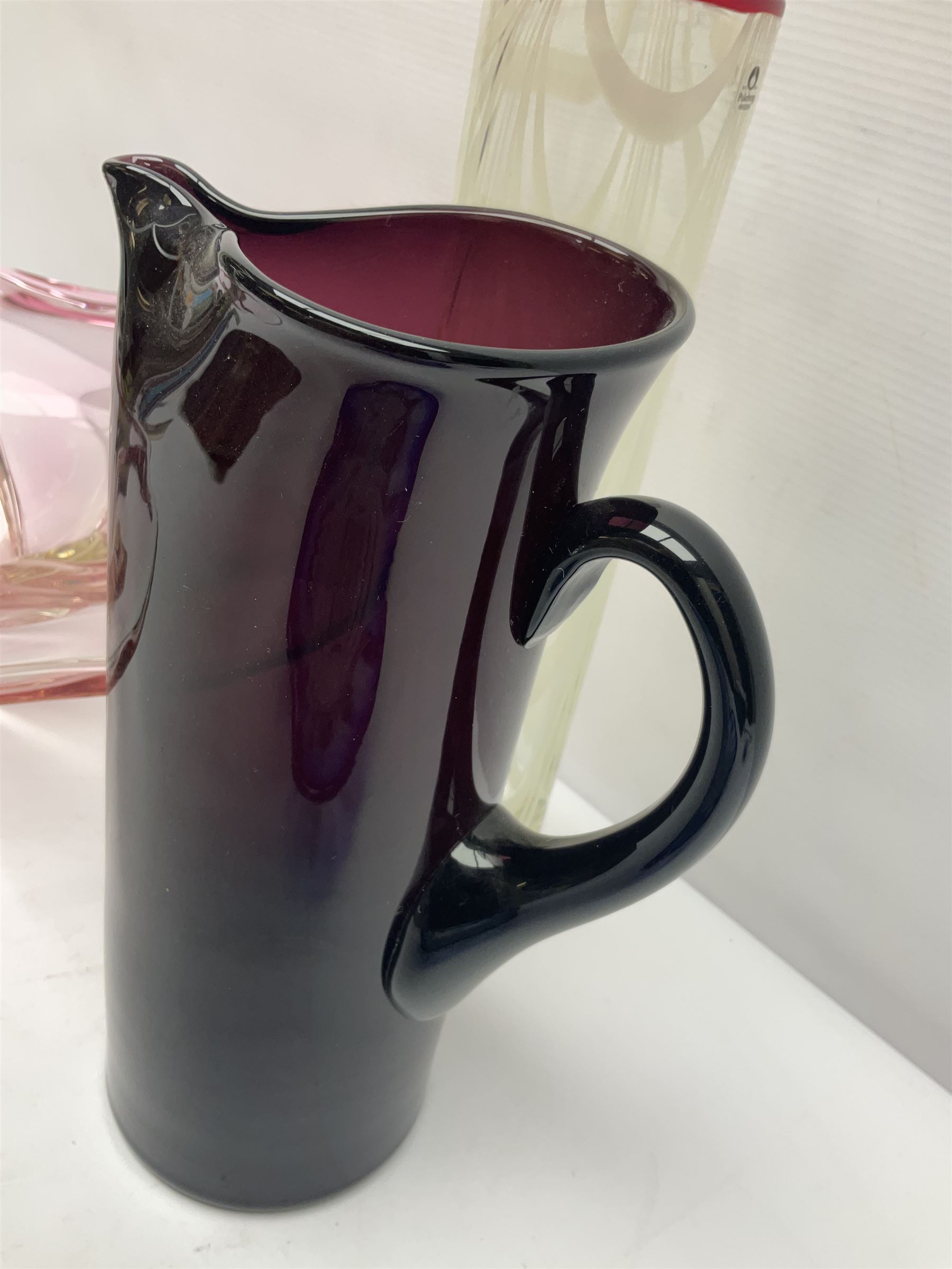 Two Whitefriars glass jugs, together with a Swedish Pukeberg art glass vase and three art glass bowls, including large pink example, some signed to base, tallest H30.5cm