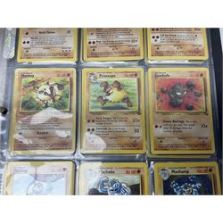 Collection of Pokemon trading cards, mostly 1999 Wizards Pokemon cards to include holo Charizard 4/102, first edition holo Machamp 8/102, further holographic cards; Dark Flareon 35/82 and Dark Vaporeon 45/82, cards from themed sets and 4th edition prints; 1998 Electronic Pokédex with cardboard boxes for themed decks Blackout, Overgrowth and Power Reserve Jungle, along with a large quantity of energy and trainer cards 