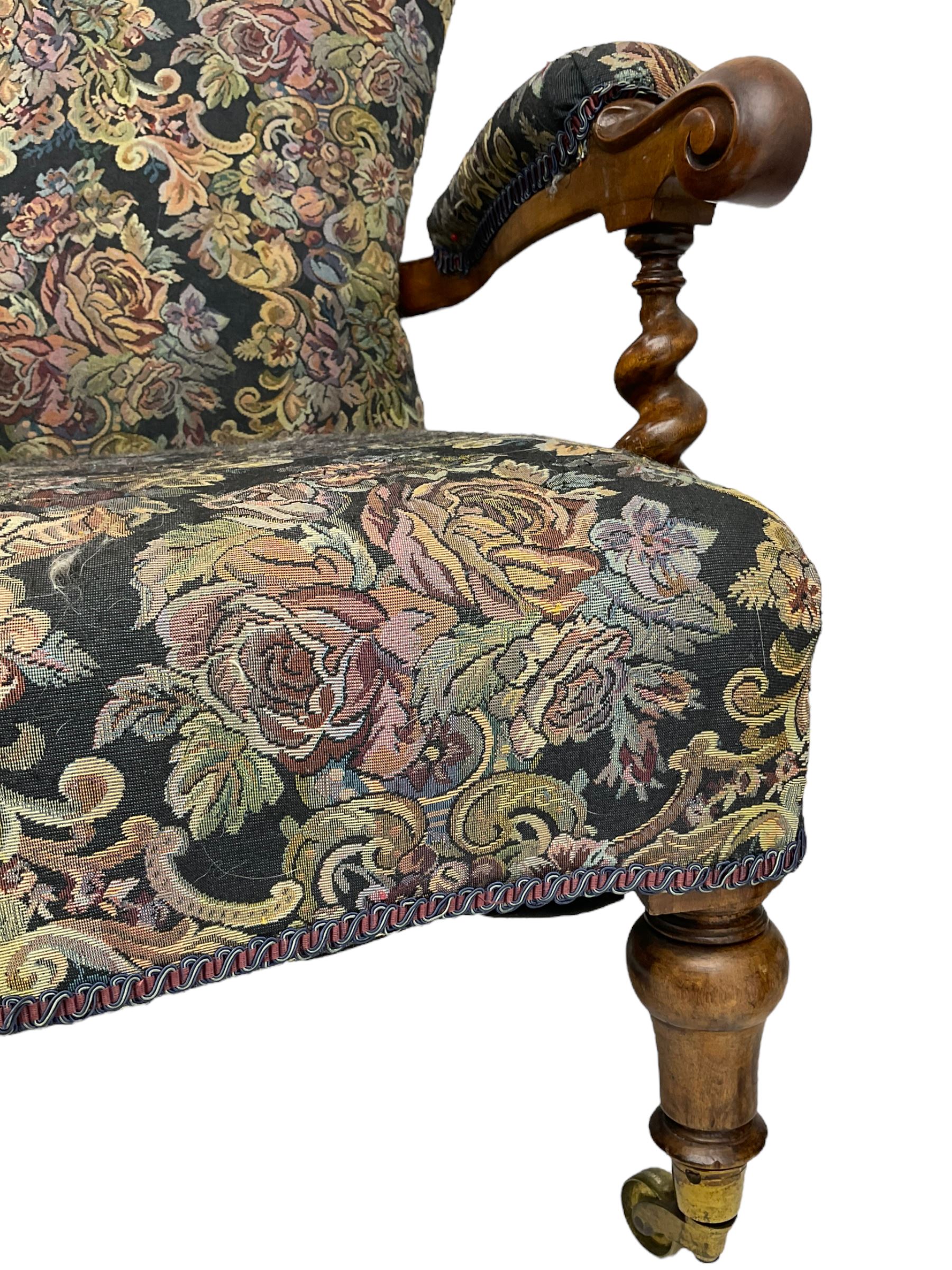 Victorian walnut framed open armchair, scrolled arm terminals over spiral turned arm supports, upholstered in foliate patterned fabric with sprung seat, on turned supports and brass castors (W65cm H92cm); and Victorian mahogany nursing chair with lobe carved supports (W60cm H92cm)