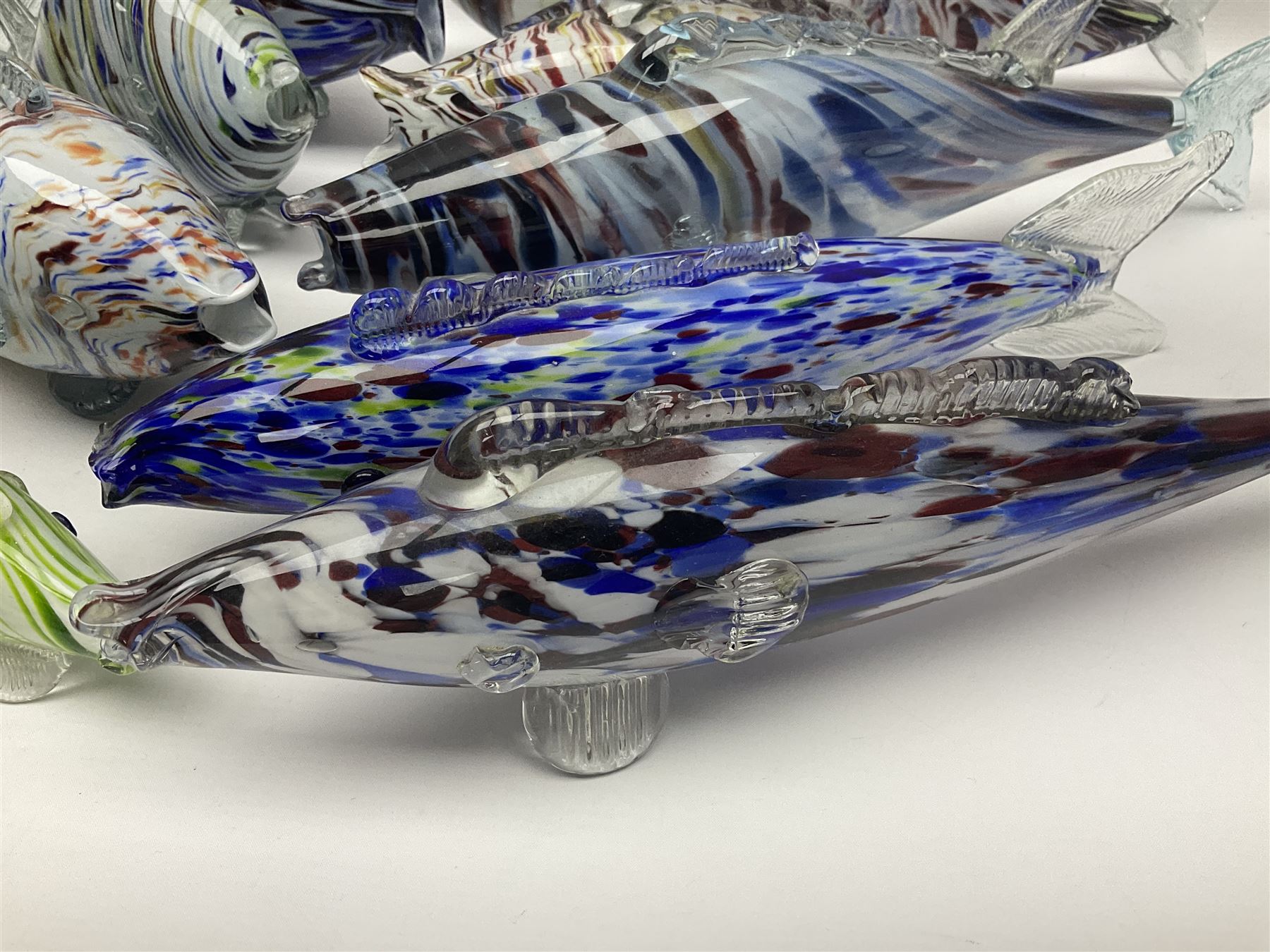 Collection of mid 20th century murano style glass fish, each with multi coloured inclusions largest L42cm