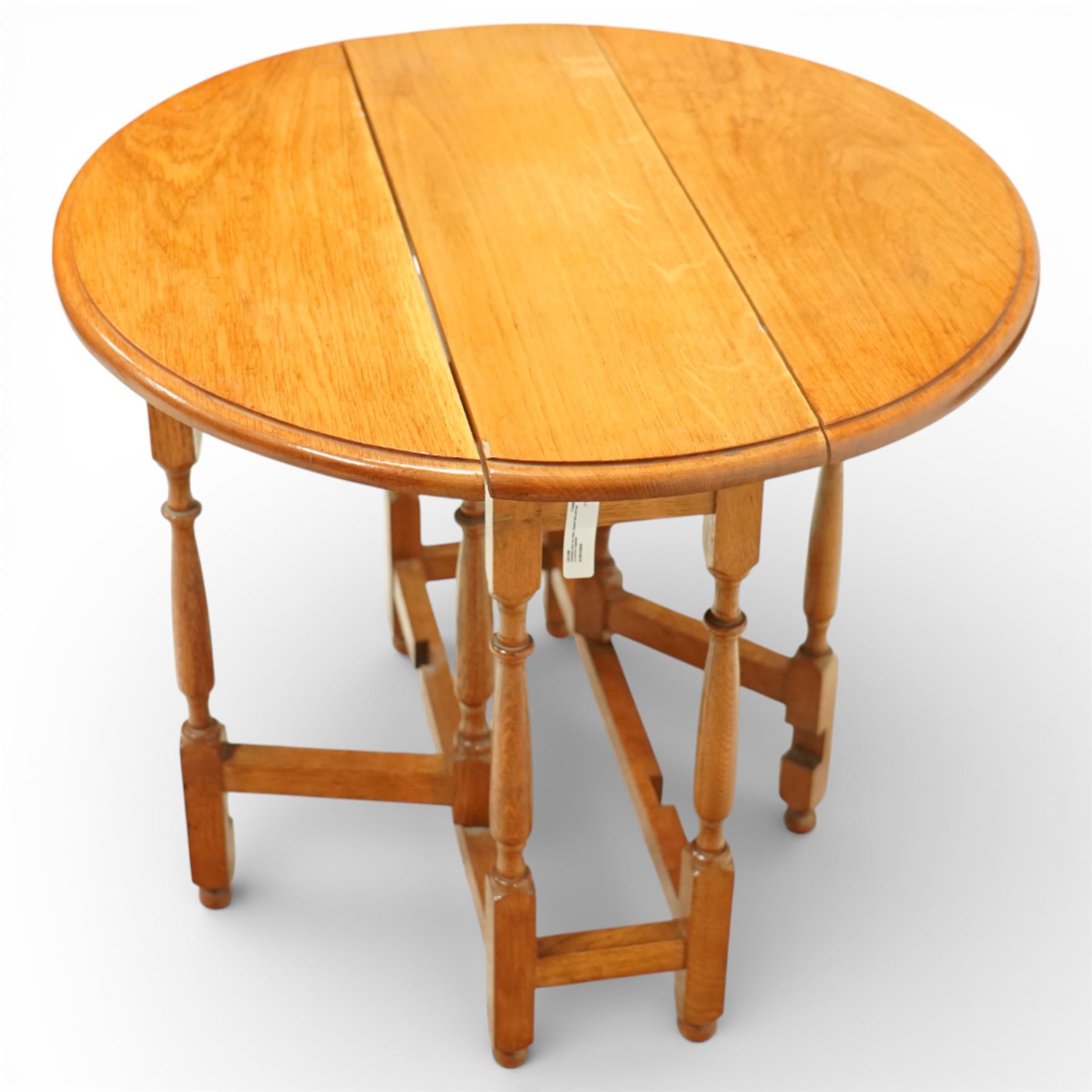 Late 20th century small oak gate leg side table, with circular drop-leaf top formed of three planks, raised on turned supports with gate legs and rectangular stretchers