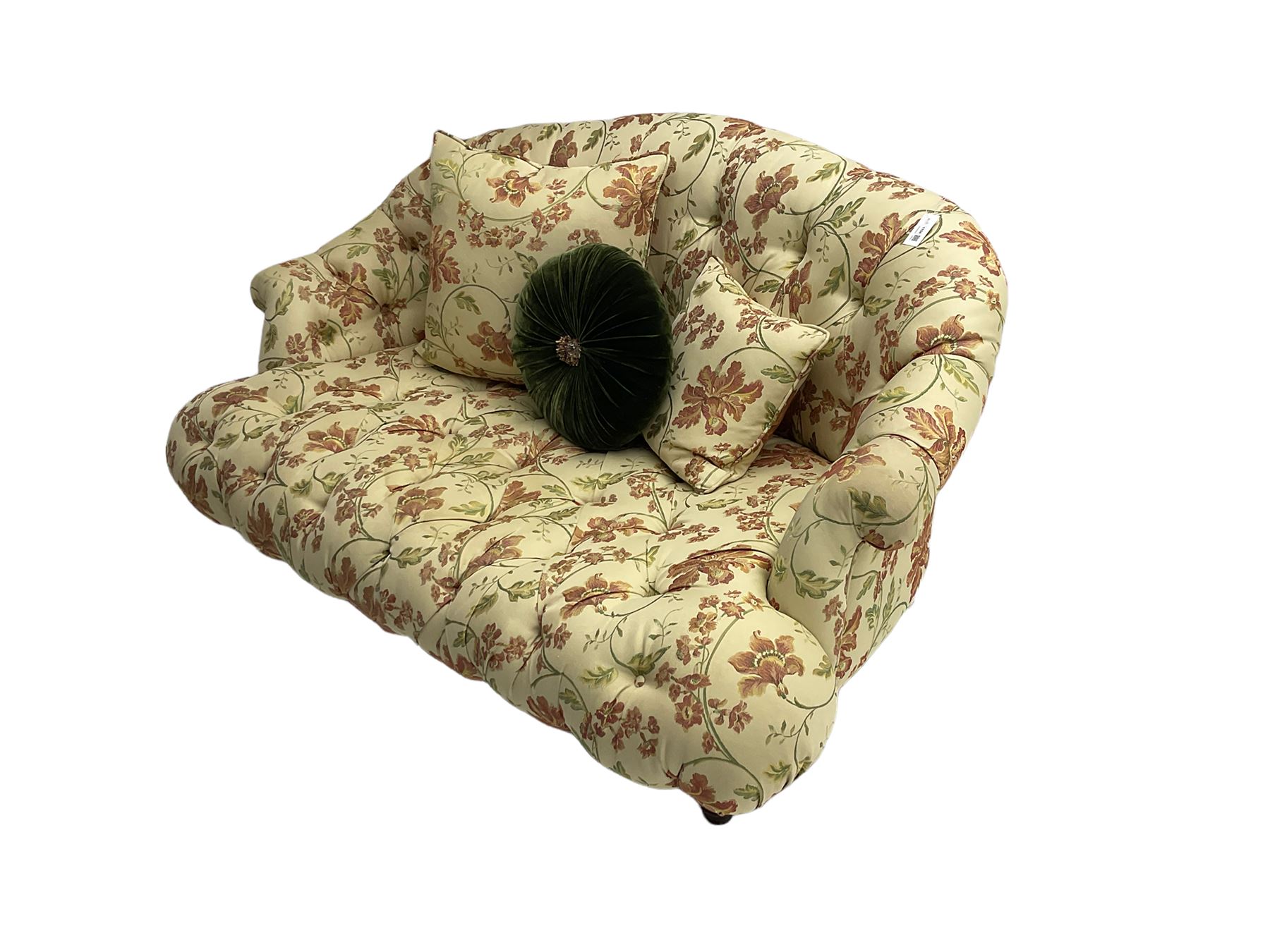 Victorian style two seat sofa, upholstered in beige ground floral floral pattern fabric, with scatter cushions, turned feet with brass castors