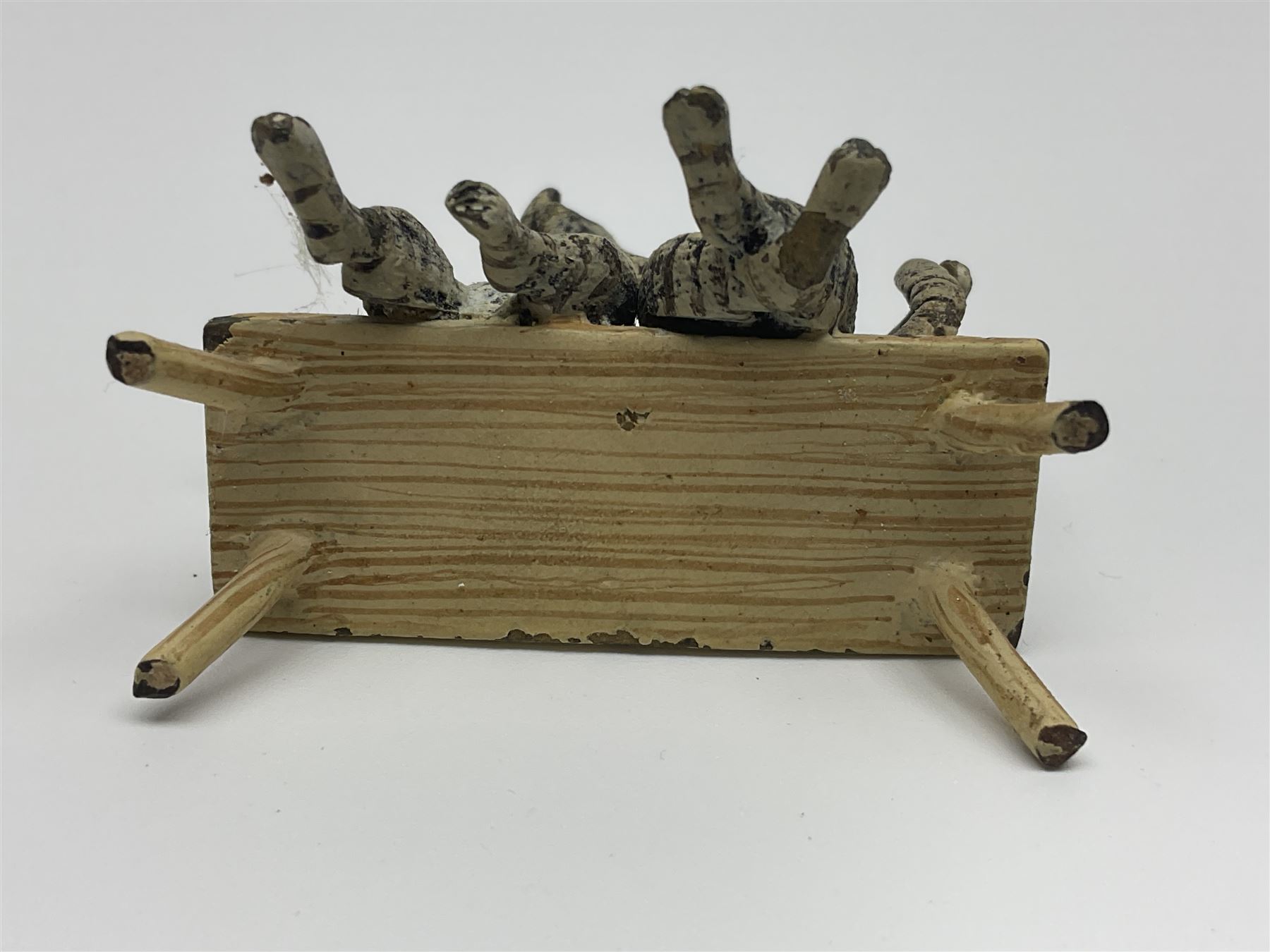 After Bergmann, two cold painted bronze figures, the first modelled as two cats on a bench hugging, the second a cat caning a kitten