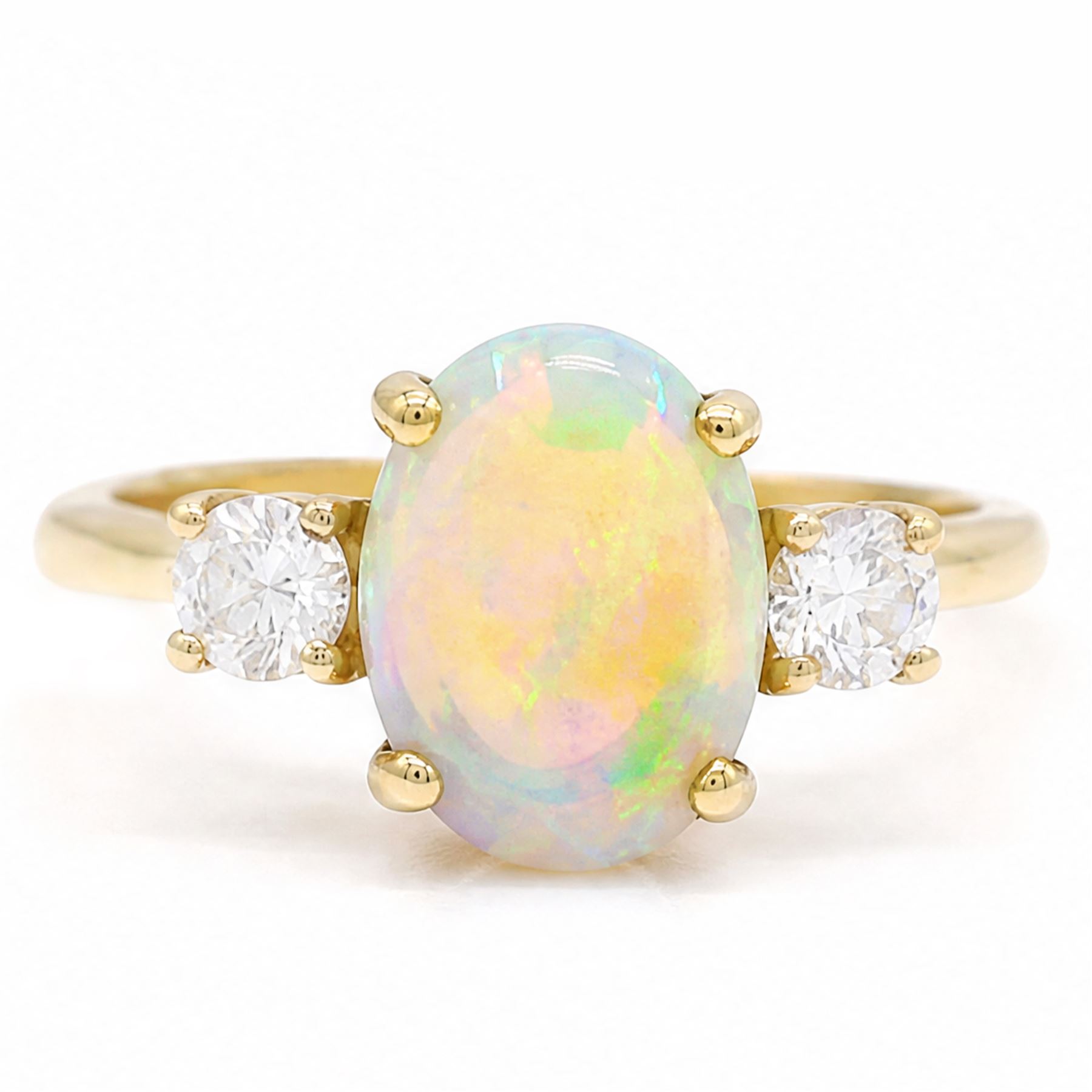 18ct god opal and diamond three stone ring, single oval cabochon cut opal of approx 2.80 carat, with a round brilliant cut diamond set either side, hallmarked, total diamond weight approx 0.25 carat