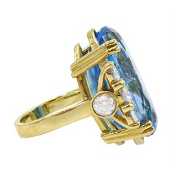 18ct gold blue topaz and diamond ring, single oval cut blue topaz of approx 31.10 carat, with four round brilliant cut diamonds set either side and a further two diamond set to the gallery, London 2019, total diamond weight approx 2.25 carat