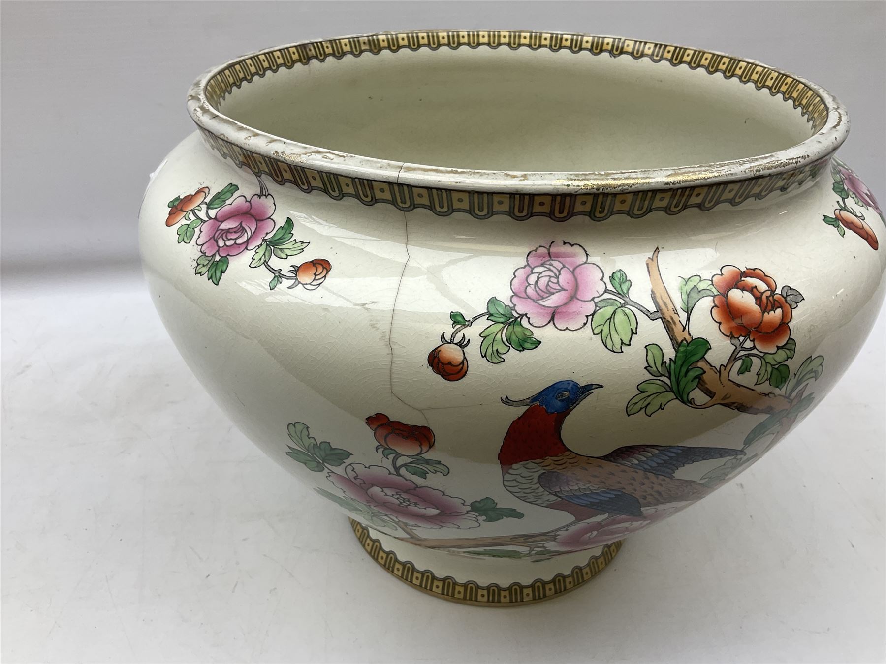 Large ceramic Jardiniere on stand, decorated with an oriental pheasant perched upon branches blossoming with peonies and foliage on white ground, overall H99cm