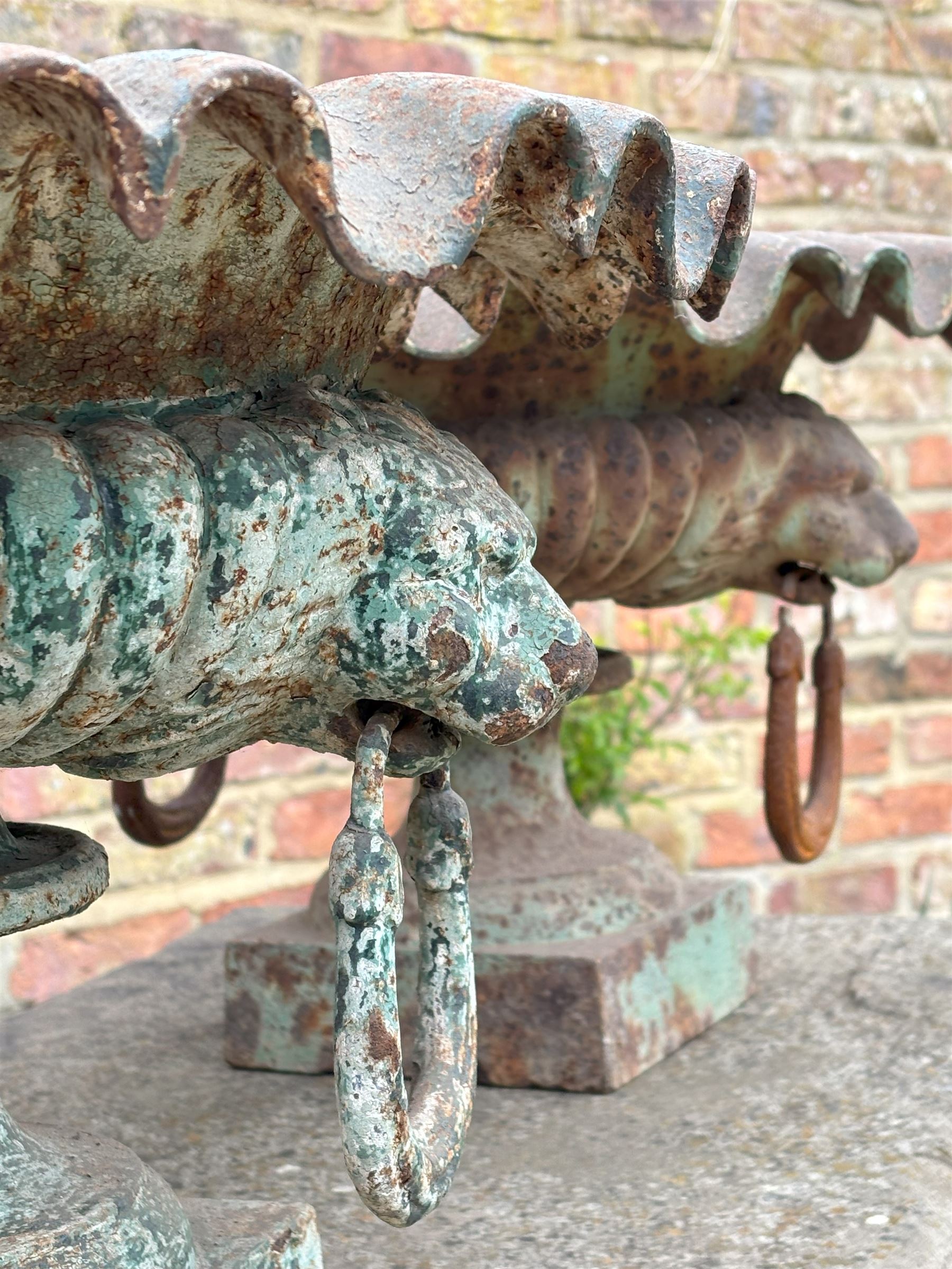 Pair of French cast iron garden urns, each with scalloped edge above lion mask and loop handles, on a square base. H36cm, D73cm.  - COLLECTION BY APPOINTMENT FROM: The White House, Thirsk Road, Easingwold, York, YO61 3NF - CALL 01723 507111 TO ARRANGE