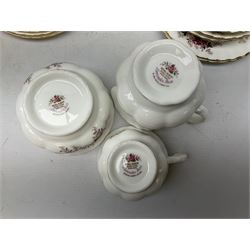 Royal Albert part tea service decorated in the 'Lavender Rose' pattern, comprising four teacups, six saucers, six side plates, jug, sucrier and cake plate, all stamped beneath