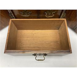 Victorian oak smoker's cabinet / cigar and cigarette box modelled in the form of a two door safe, the hinged twin doors with applied Royal crests opening to reveal one long drawer over two short drawers, H23cm