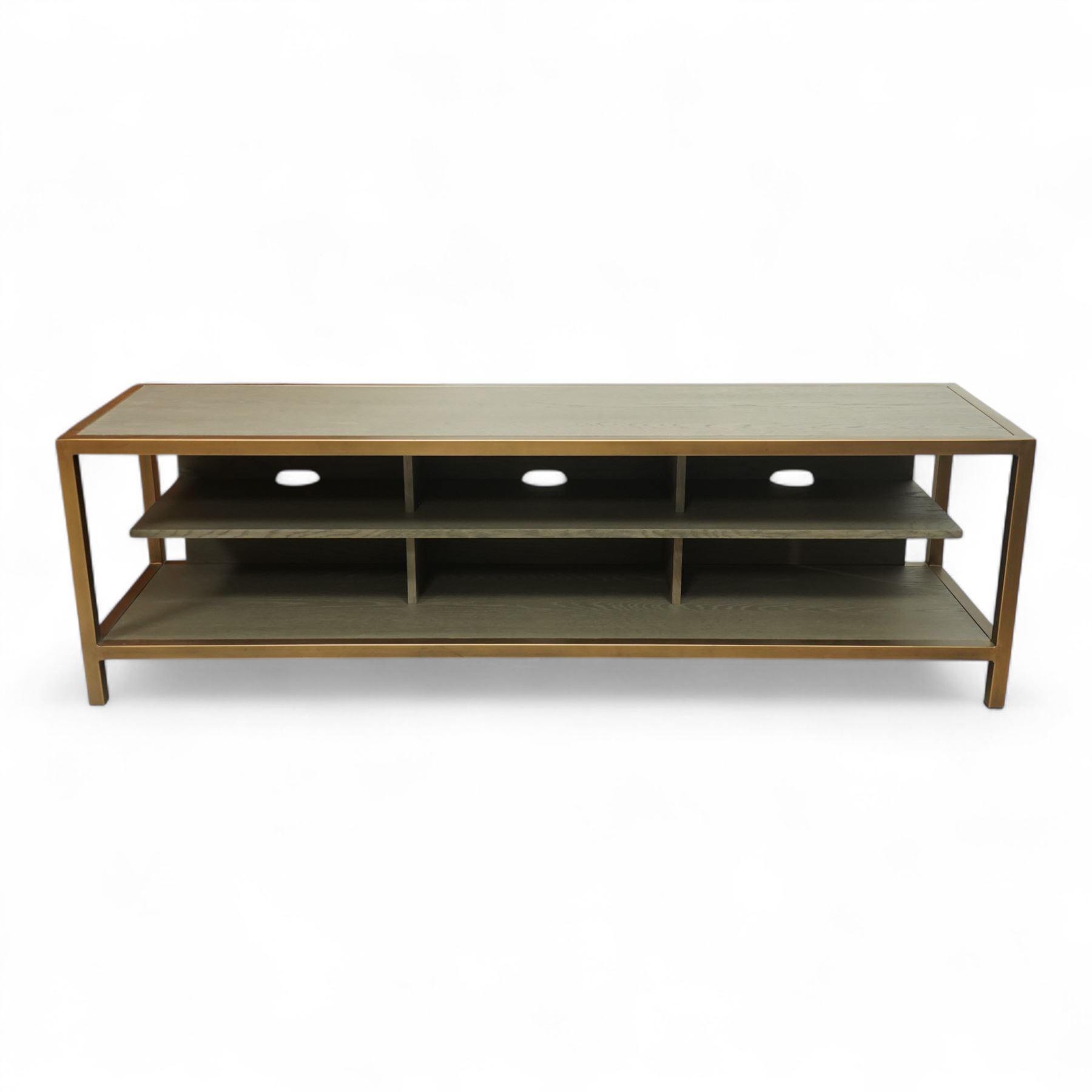 Contemporary low television stand, brass-effect metal frame enclosing six open oak veneered compartments, raised on square tubular supports
