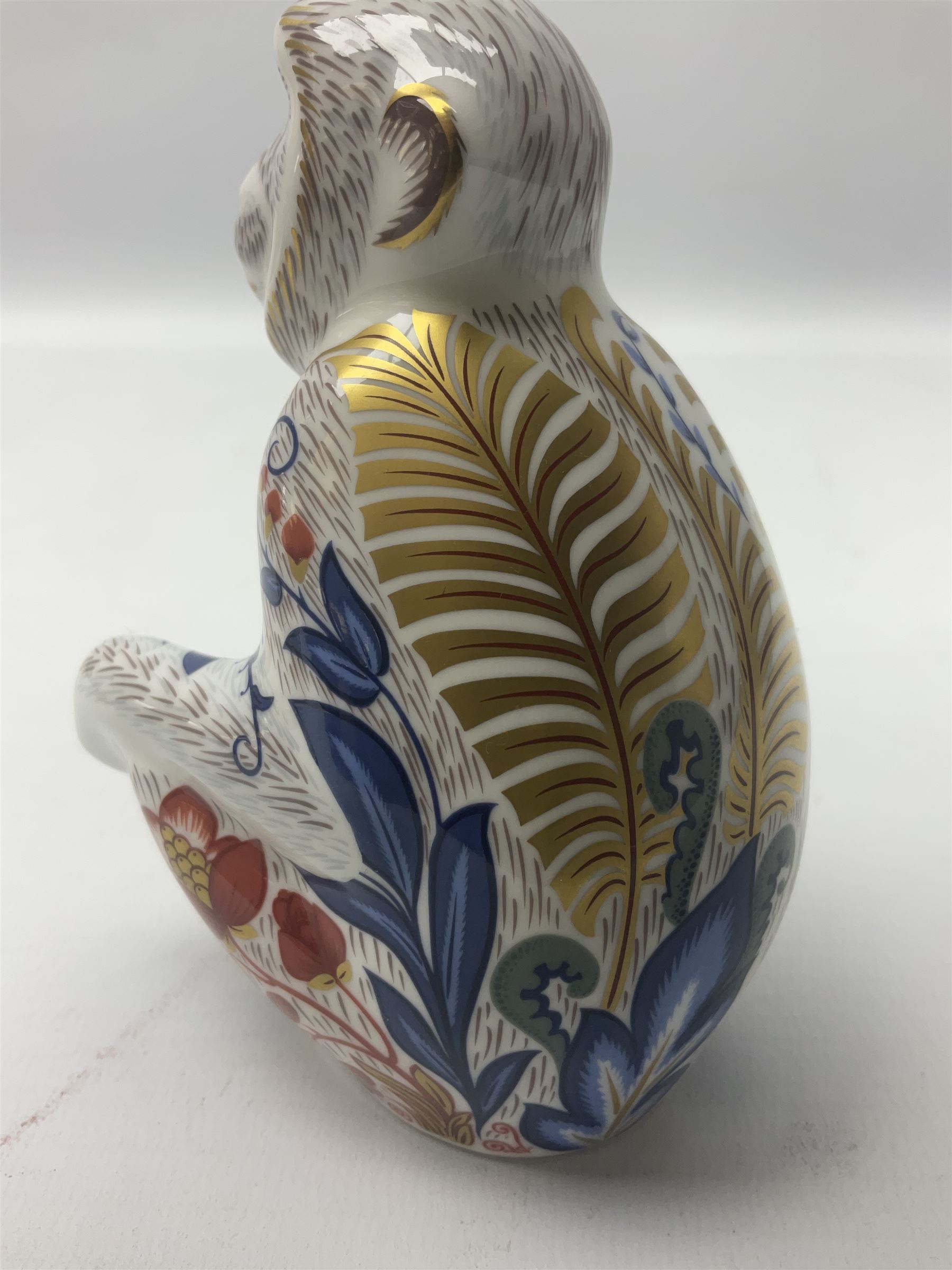 Three Royal Crown Derby paperweights, comprising Macaque, with gold stopper and original box, Monkey and Baby, with silver stopper and original box and Dragon with silver stopper, all with printed mark beneath  