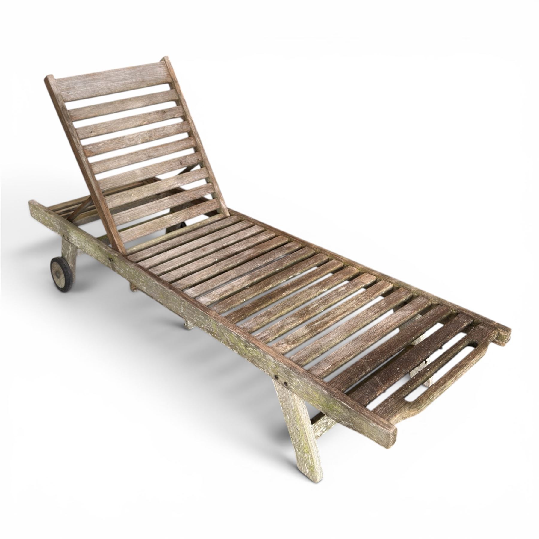 Pair of teak garden sun loungers, with slatted adjustable backrests, integrated wheels and sliding pull-out side trays, weathered natural finish.