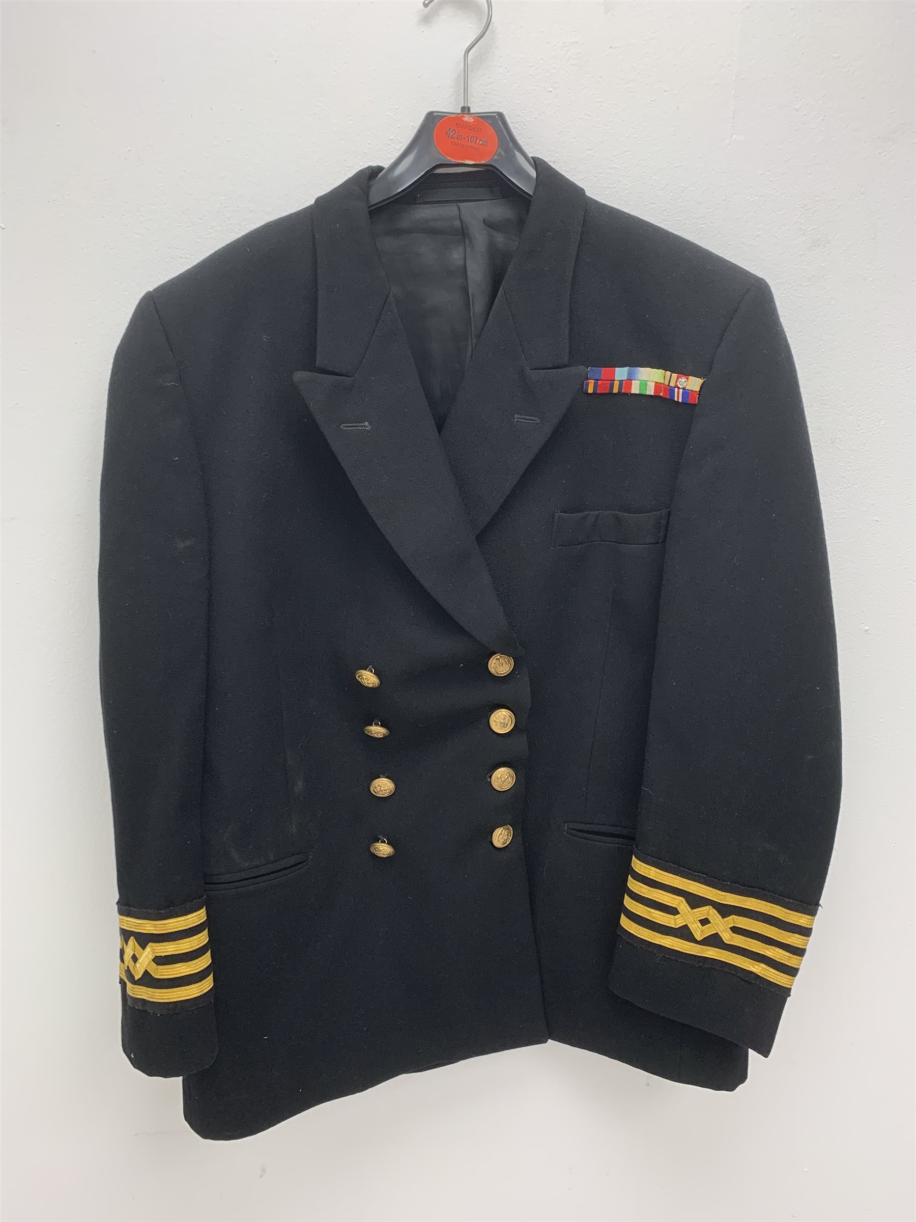 Merchant Navy captain's uniform with WW2 medal ribbons and peaked cap, epaulettes, spare cuff braiding, quantity of buttons and metal badges and two books of maritime interest