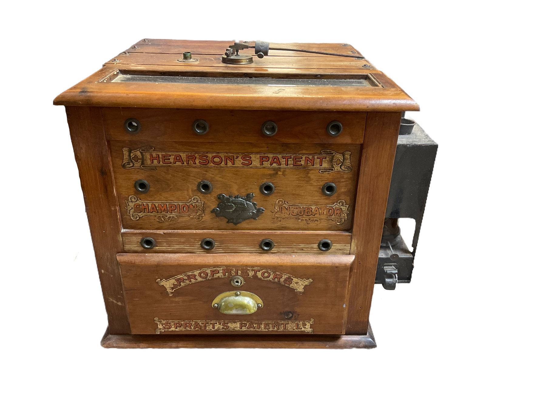 'Hearson's Patent Champion Incubator' mahogany paraffin egg incubator, decorated with 'Proprietors
Spratt's Patent Ld' in gilt scrolls, with central plaque and brass handle, H52cm W54cm excl side fitting