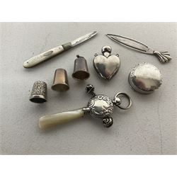 Group of silver, comprising baby's rattle and fruit knife, both with mother of pearl handles, heart shaped pendant, pill box, page marker, frog design thimble and two other silver thimbles, all hallmarked 