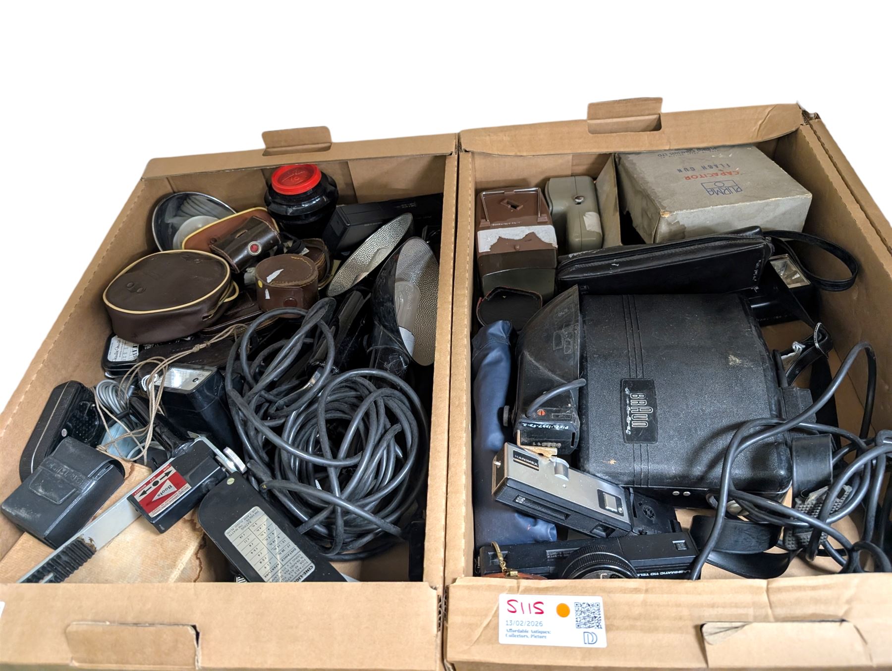 Collection of camera flashes and light meters, including Weston Master light meters, Braun Hobby flash, Hanimex XP1, in two boxes