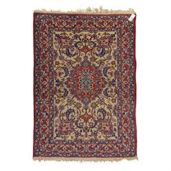 Kashan design wool rug, with red floral medallion on a cream field, decorated with scrolli...