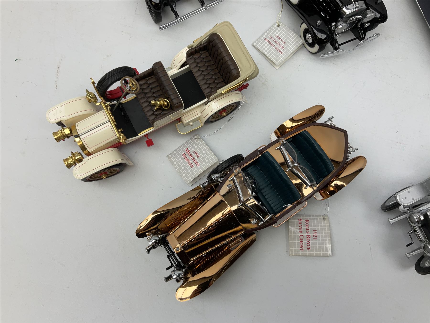 Eight Franklin Mint diecast models of cars, 1911 Rolls-Royce Tourer, The Rolls-Royce Corniche IV, The Mercedes Simplex, 1955 Rolls-Royce Silver Cloud, 1921 Rolls-Royce Silver Ghost, 1907 Rolls-Royce Silver ghost,1929 Rolls-Royce Phantom I,  and 1930 V-16 452 Cadillac Imperial Sedan, all with original tags attached