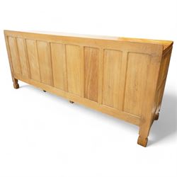 Mouseman - adzed and panelled oak 6' sideboard, fitted with four central drawers and flanking cupboards, enclosed by two panelled doors with wrought metal latches and hinges, on octagonal feet, carved with mouse signature, panelled sides, by the workshop of Robert Thompson, Kilburn 