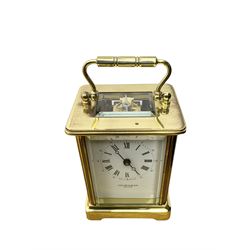 Taylor & Bligh - English 8-day carriage clock in a corniche-style case, white dial with roman numerals and steel moon hands, 11 jewel movement with a lever platform escapement. With key.