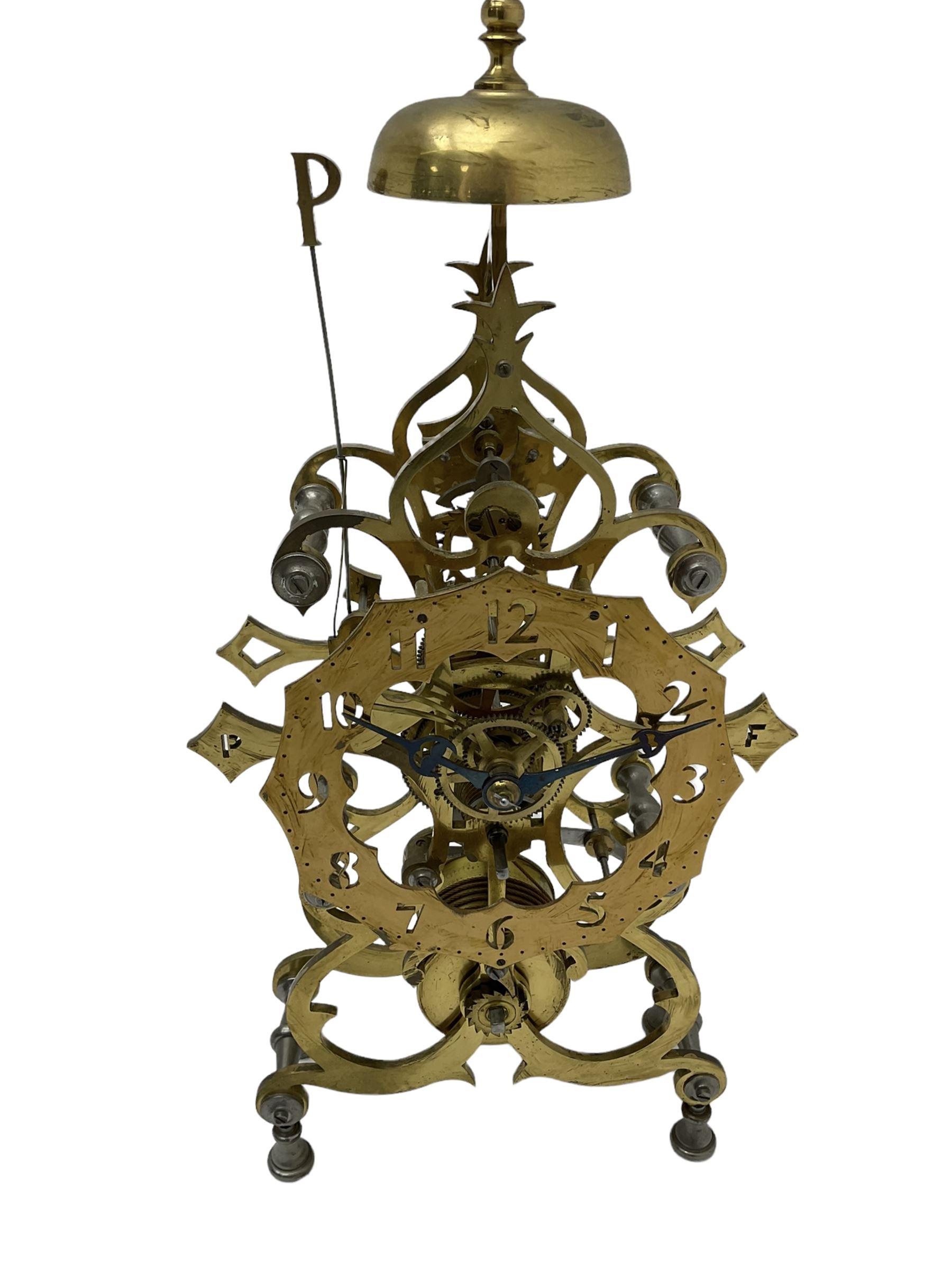 20th century scroll pattern Skeleton clock to the construction design of John Wilding, with an 8-day fusee movement and passing strike, with lantern pinions and brass wheels, Skeletonised brass dial with pierced Arabic numerals, cylindrical pendulum bob, with bespoke key and original construction book. 
John Wilding was a highly respected engineer and clockmaker publishing many books on the construction and repair of Fusee and weight driven clocks.

