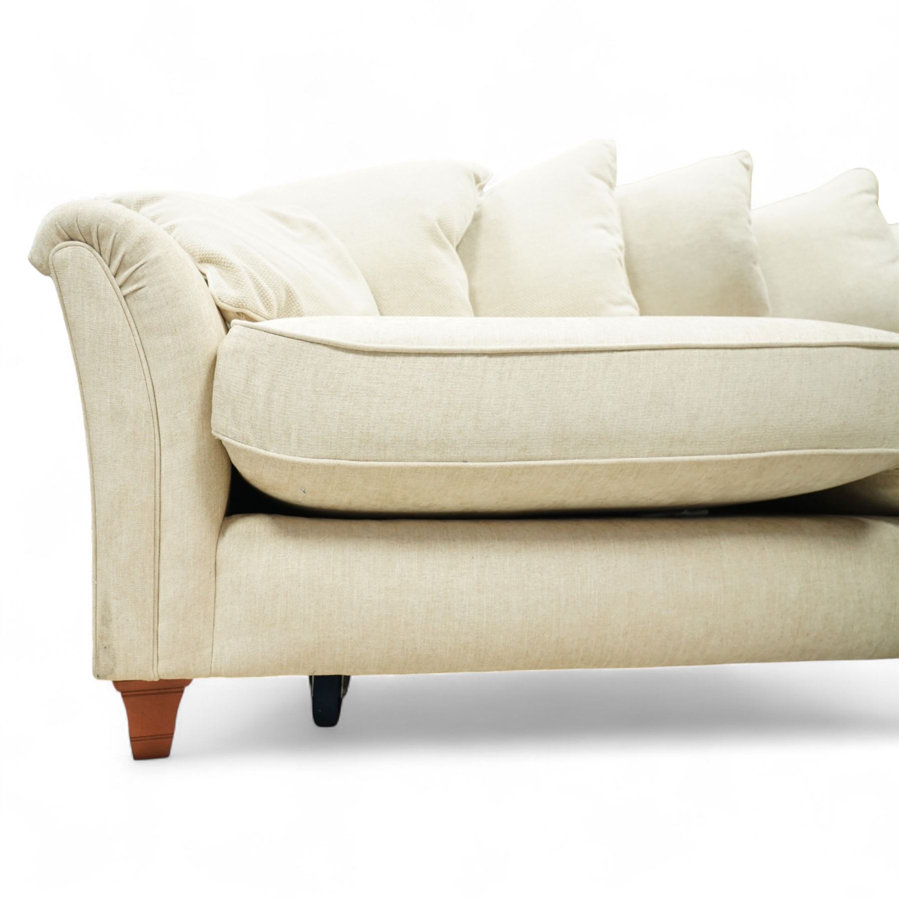 Parker Knoll - contemporary beige upholstered two seat sofa, with flared scroll arms and loose back and seat cushions, standing on stained tapered block feet