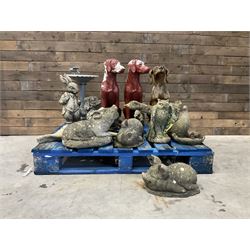 Various cast stone and composite garden ornaments, to include Peter Rabbit, goose, pigs, dogs, dog with wheelbarrow, painted metal bird bath and other, on two pallets