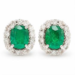 Pair of 18ct white gold emerald and diamond cluster earrings, each stud set with a cushion...