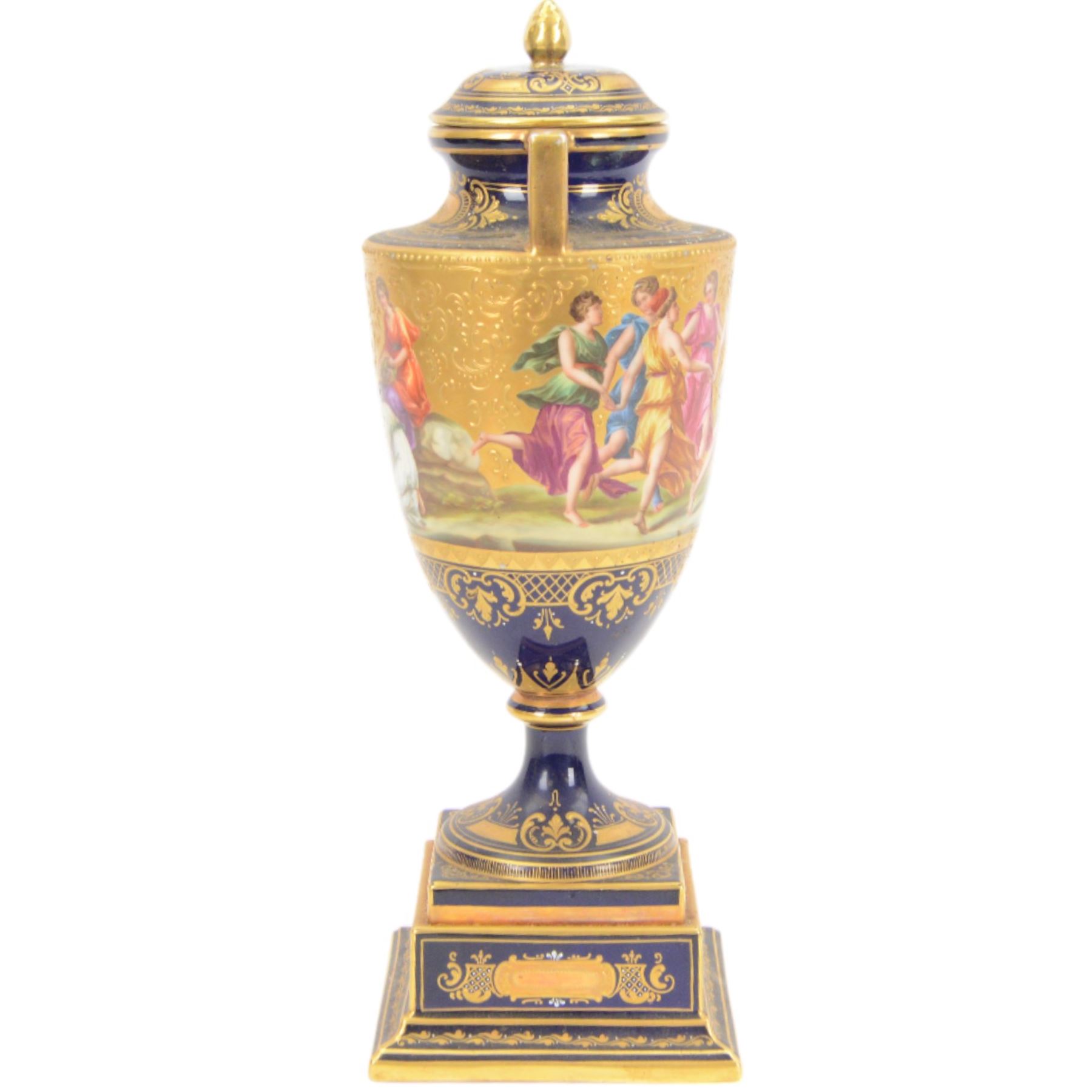 Late 19th century Vienna twin handled urn and cover decorated with classical figures on a textured gilt ground,  upon a square stepped cobalt blue pedestal with gilt detailing, H36cm