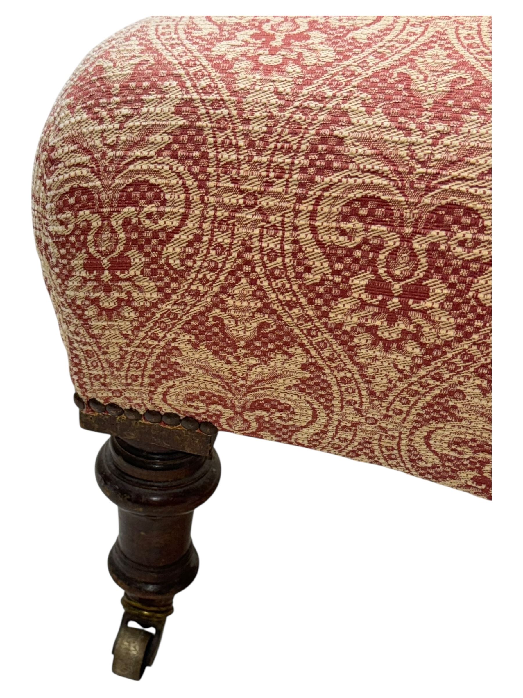 Late Victorian upholstered armchair, with high camel back and deep seat, padded arms and backrest in crimson and cream damask-style fabric, raised on turned ebonised front supports with ceramic castors (H88cm, W65cm, D 60m); and an Edwardian bedroom chair with button upholstered rail back (H72cm, D64cm, W53cm) (2)