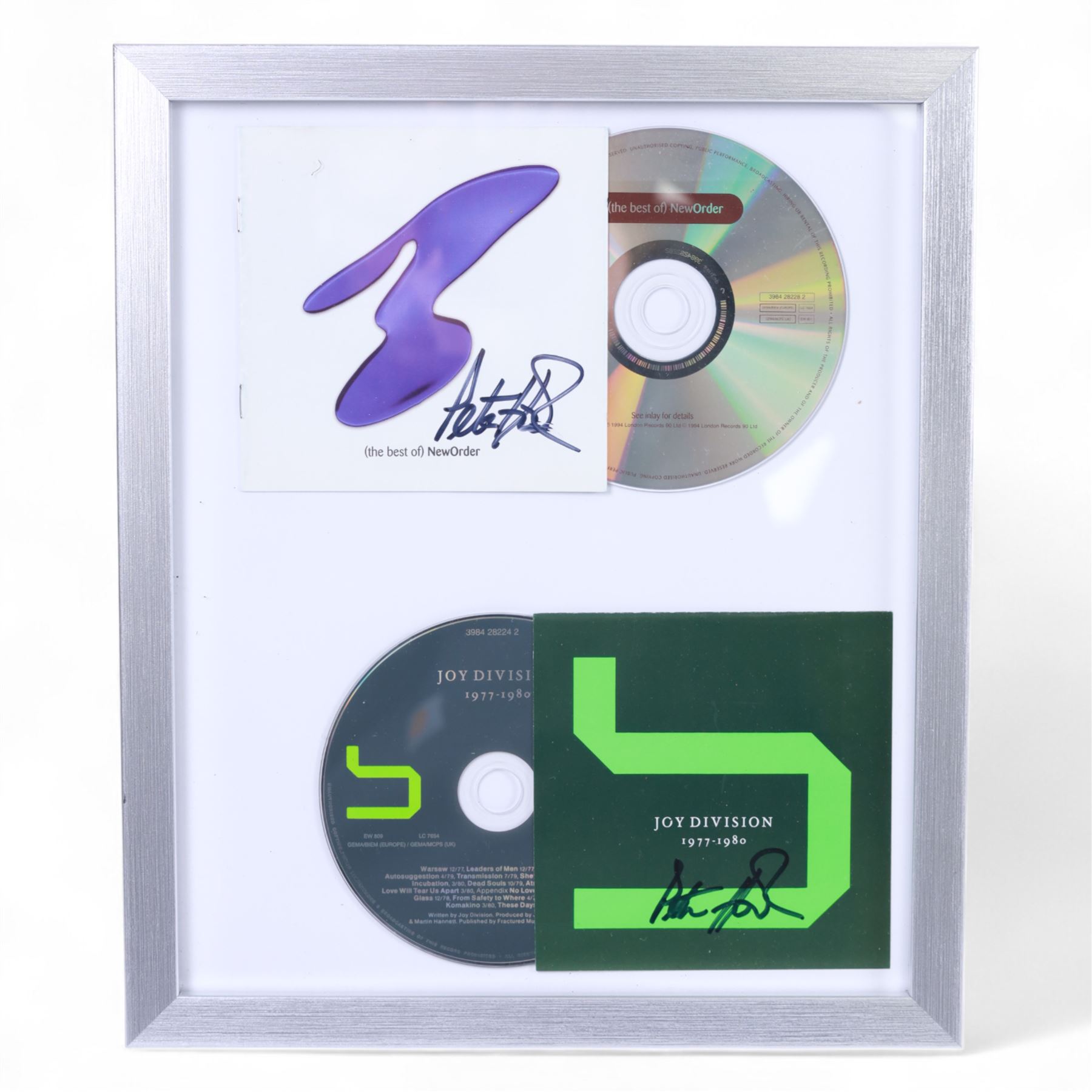 Joy Division/New Order framed album inserts and CDs, both signed by Peter Hook, together with three signed Peter Hook books 'Unknown Pleasures', 'Substance' and 'The Hacienda' and two The Hacienda t-shirts, frame H33cm