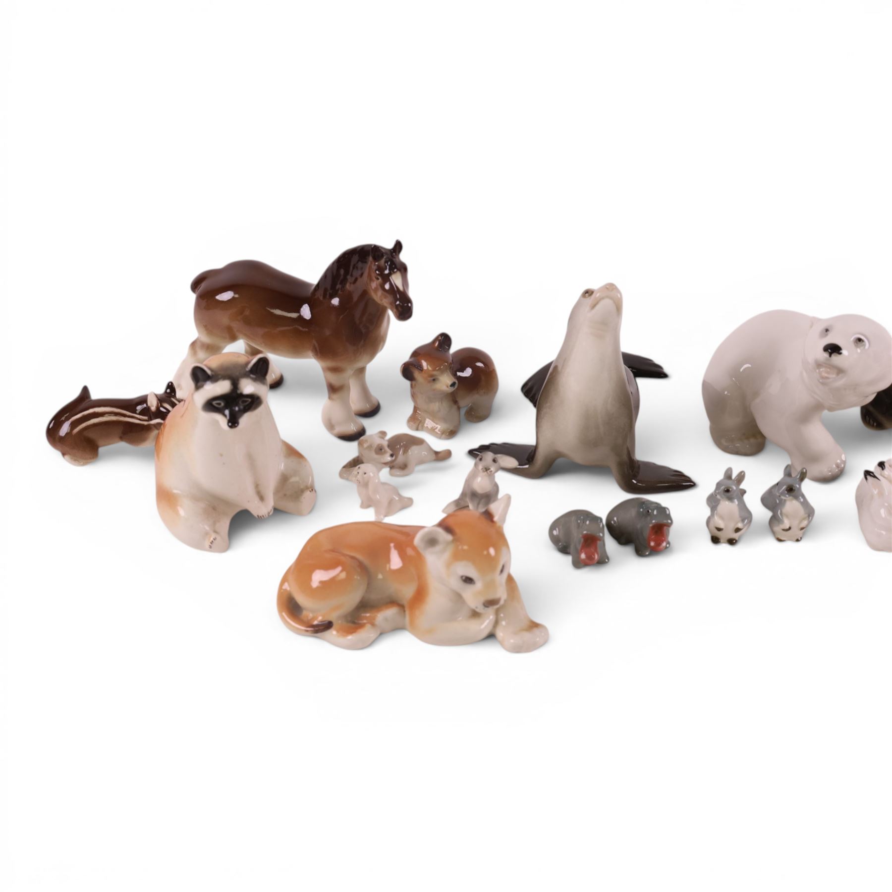 Collection of USSR Lomonosov figures, including racoons, sea lion, horse, lion cubs etc 
