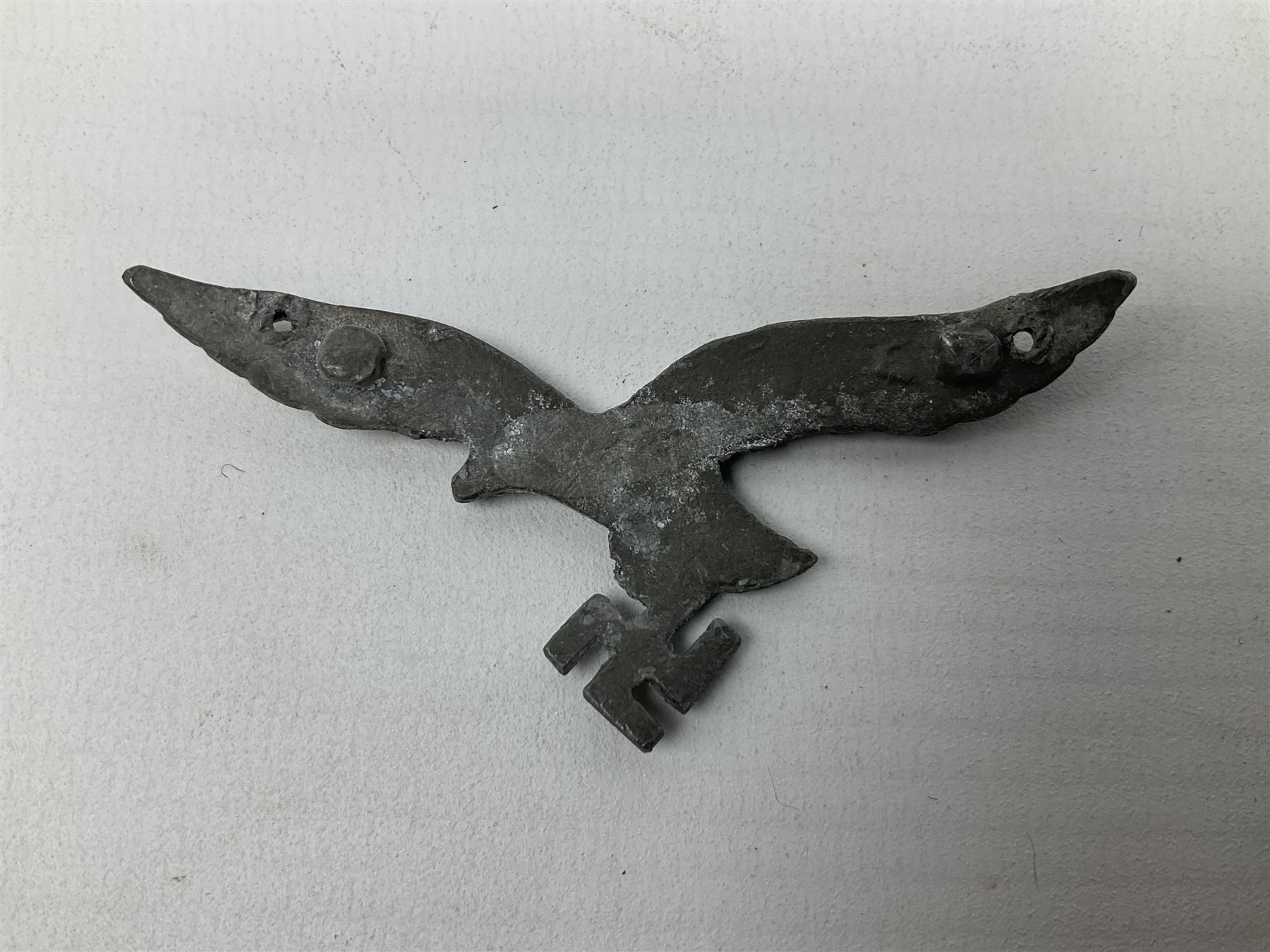 Five WW2 German peaked cap badges, four with double-pinned backs