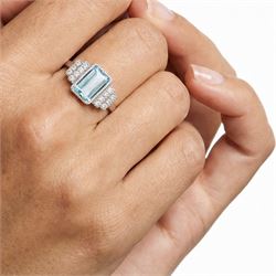 18ct white gold aquamarine and diamond stepped design ring, single milgrain set octagonal cut aquamarine of approx 7.00 carat, with seven round brilliant cut diamonds set either side, stamped 750, total diamond weight approx 0.40 carat