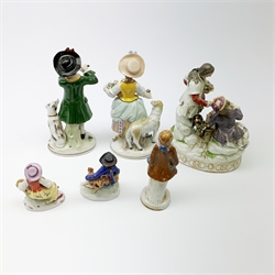 A pair of Sitzendorf porcelain figures, the first modelled as a boy playing the flute, with dog seated at his feet, the second modelled as a girl with basket of flowers and sheep stood beside her, each upon oval gilt detailed base, each with printed mark beneath, H17cm, together with a Naples figure group, a pair of small Sitzendorf figurines, and a later example marked Japan. (6). 