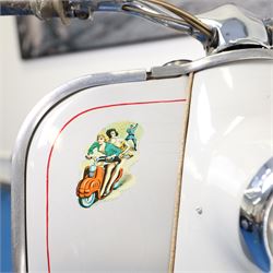 1957 Zündapp Bella R154 Scooter

• Registration: 150 KPU
• Year: 1957
• Model: Bella R154
• Engine: 150cc two-stroke single-cylinder petrol
• Transmission: Four-speed manual
• Odometer reading: 1,727 miles
• Colour: Ivory
• Seating: Dual seat
• V5C: Present
• Original registration book: Present
• Keys: 1

A characterful 1957 Zündapp Bella R154 scooter, finished in ivory with a contrasting brown dual seat and displaying an odometer reading of 1,727 miles.

The Bella R154 formed part of Zündapp’s distinctive range of German touring scooters, combining a 150cc air-cooled two-stroke engine with four-speed transmission, large wheels and substantial pressed-steel bodywork. This example retains its enclosed front apron, central headlamp, chrome handlebars, brightwork, period VDO speedometer and decorative Bella badging.

An operation and maintenance manual is include and accompanied by its V5C and original registration book from 1957.

This vehicle forms part of the Estate of the Late John Sills and is offered for sale by the Executors, confirming a genuine reason for sale.