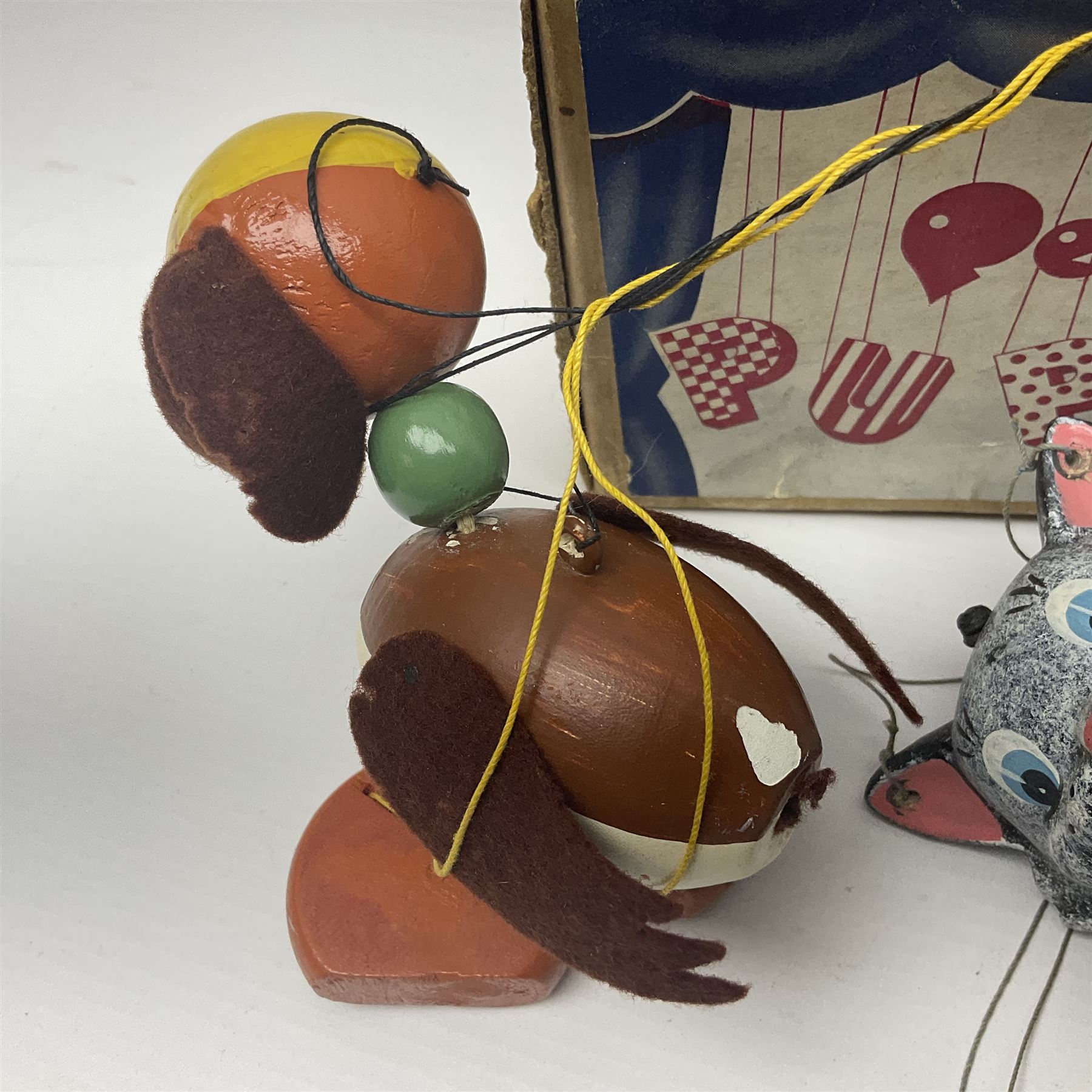 Pelham Puppet - three puppets comprising a painted wooden duck with felt mouth and wings with metal joints H12cm, in original box and instructions; and two further examples Type A cat with a hollow body H12cm, and a boy H23cm (3) 