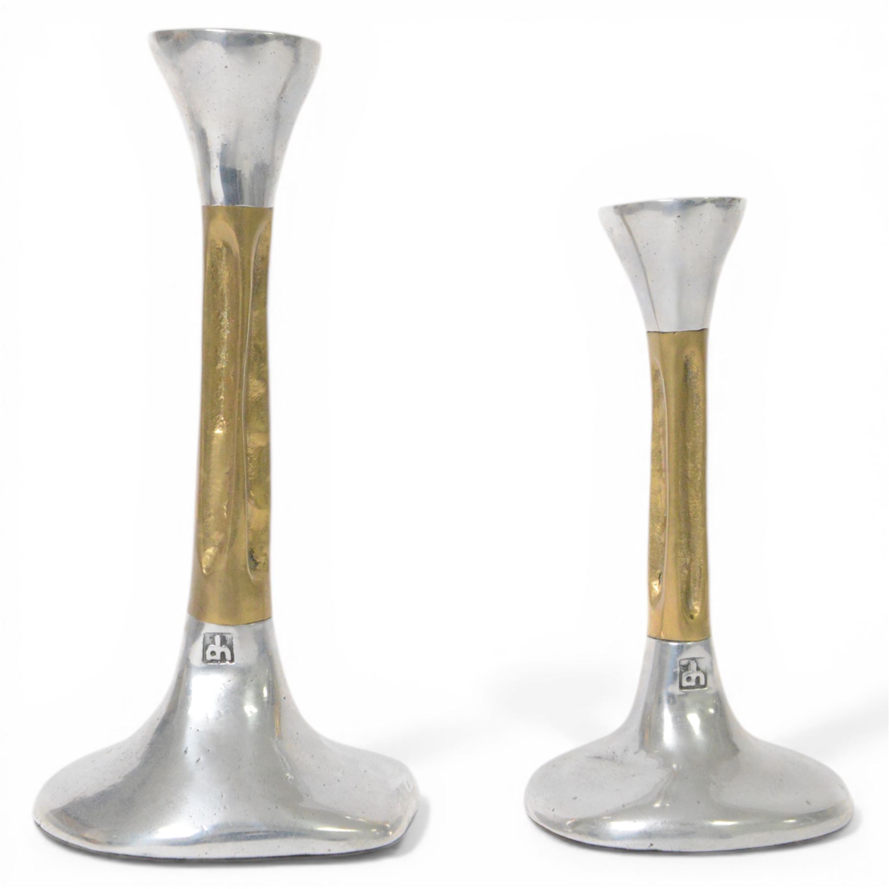 Set of David Marshall graduating candlesticks, brass and polished aluminium, makers mark impressed to stem, largest H26cm